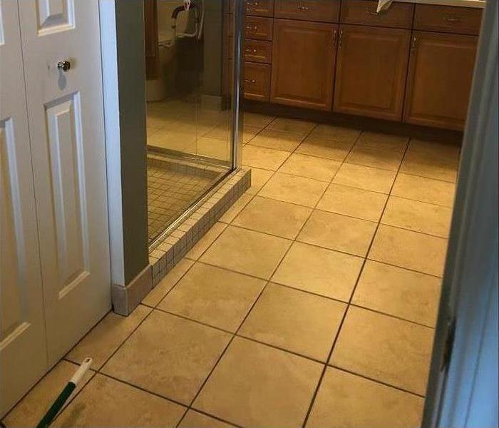 Sam bathroom with clean tile floors both in shower and on floor